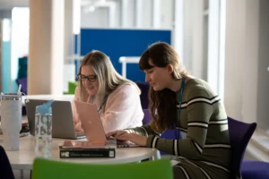 Students on laptop in library