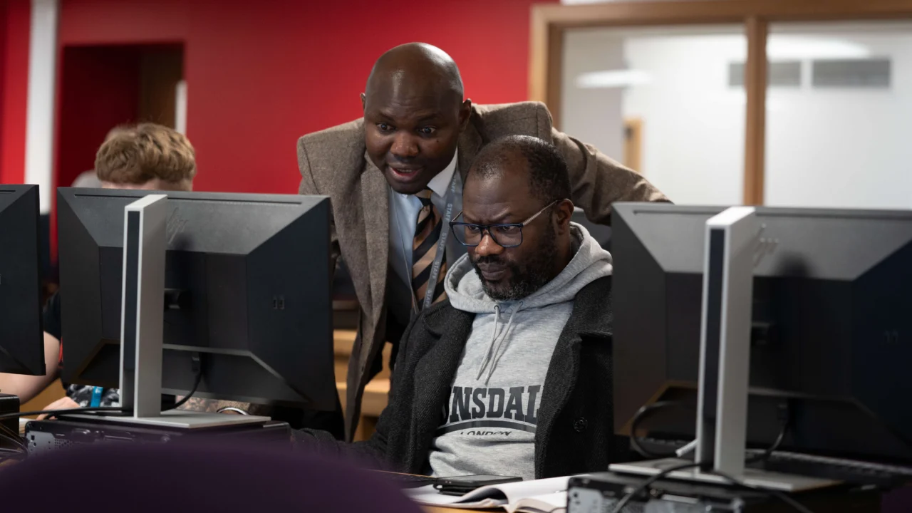 Accounting and Finance student with tutor in lecture computer room